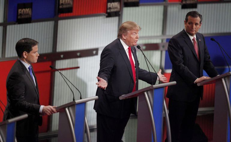 Republican U.S. presidential candidate businessman Donald Trump (C) speaks as rival candidates Senator Marco Rubio and Senator Ted Cruz (R) look on during the Fox Business Network Republican presidential candidates debate in North Charleston, South Caroli