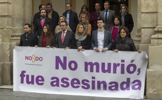 La corporación municipal sevillana junto a su alcalde, Juan Espadas (3i), guardan un minuto de silencio en la puerta del consistorio en protesta por la muerte de la mujer de 37 años asesinada este miércoles en Lebrija (Sevilla) por su expareja.