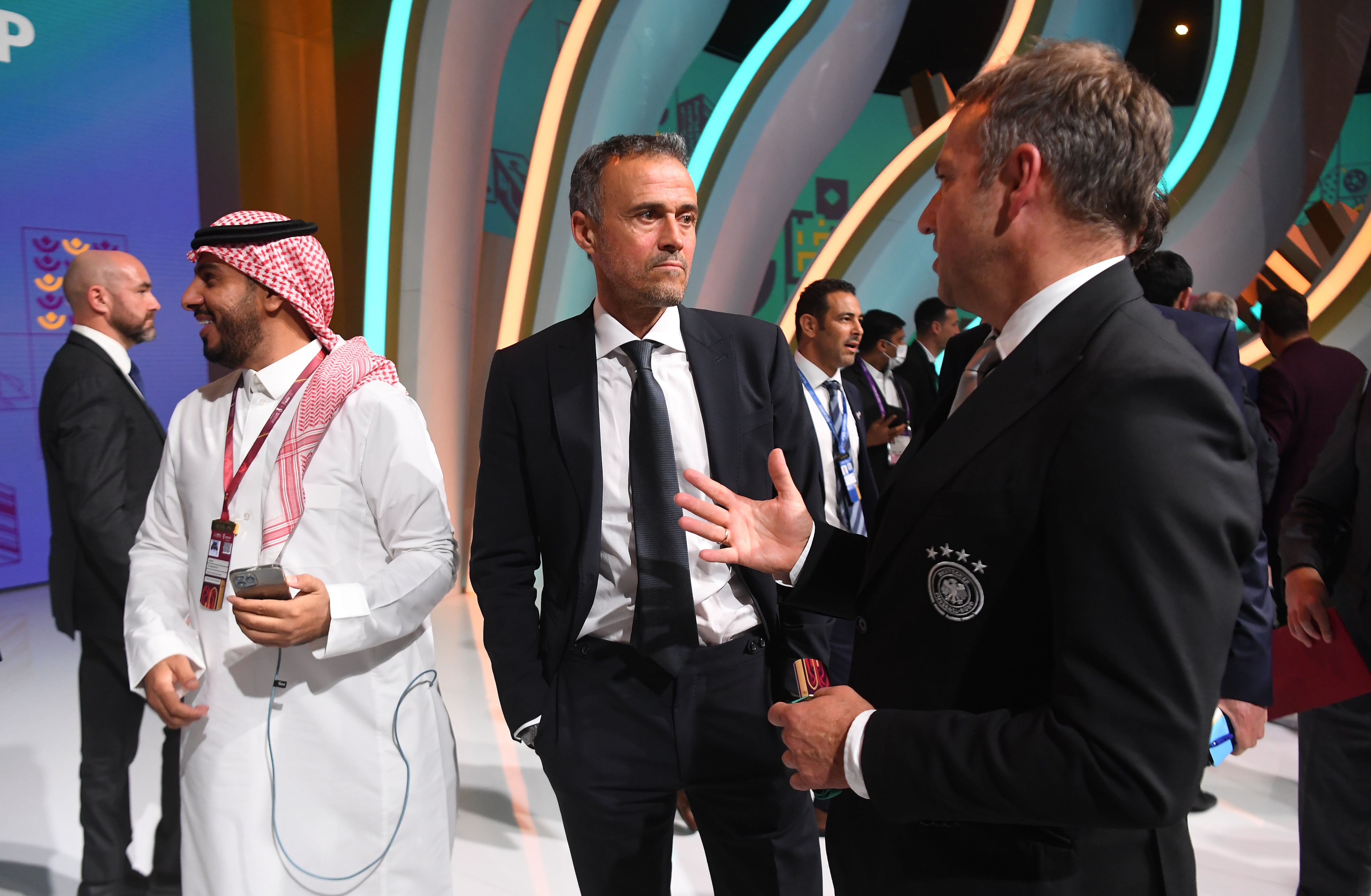 DOHA, QATAR - APRIL 01: Luis Enrique, Head Coach of Spain speaks to Hansi Flick, Head Coach of Germany during the FIFA World Cup Qatar 2022 Final Draw at the Doha Exhibition Center on April 01, 2022 in Doha, Qatar. (Photo by David Ramos/Getty Images)