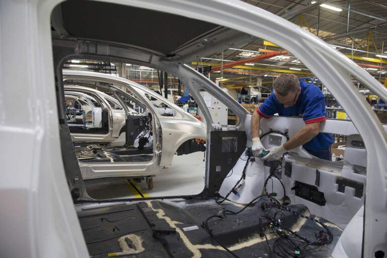 File picture shows an employee working on the automobile assembly line of Bluecar electric city cars at Renault car maker factory in Dieppe, western France, September 1, 2015