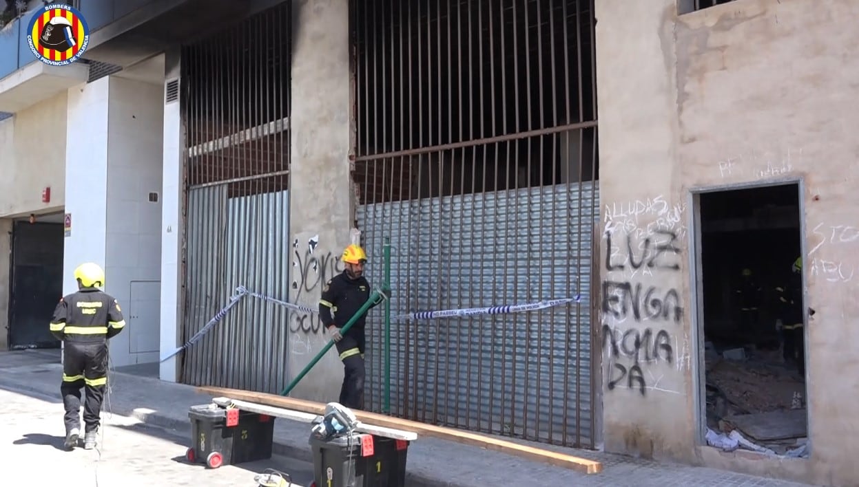 Bomberos trabajando en los bajos del edificio incendiado en Gandia.