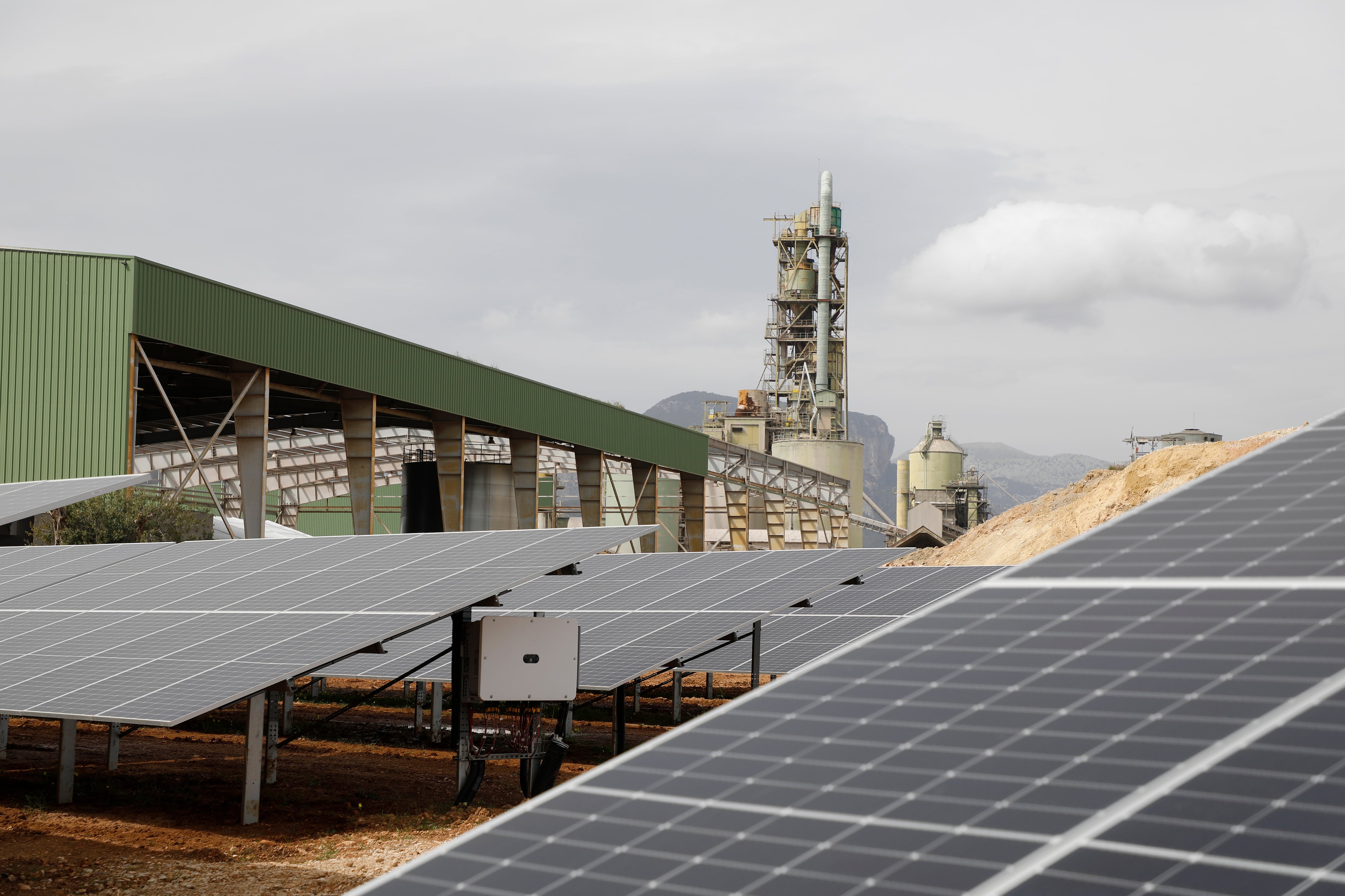 14 March 2022, Spain, Lloseta: Solar panels stand in front of an old cement factory to produce green hydrogen. It is part of the European Green Hysland project and the first industrial plant in Spain. The plant will produce green hydrogen from solar energy and water, which will be used as fuel for environmentally friendly cruises and buses, as well as hydrogen batteries. Photo: Clara Margais/dpa (Photo by Clara Margais/picture alliance via Getty Images)