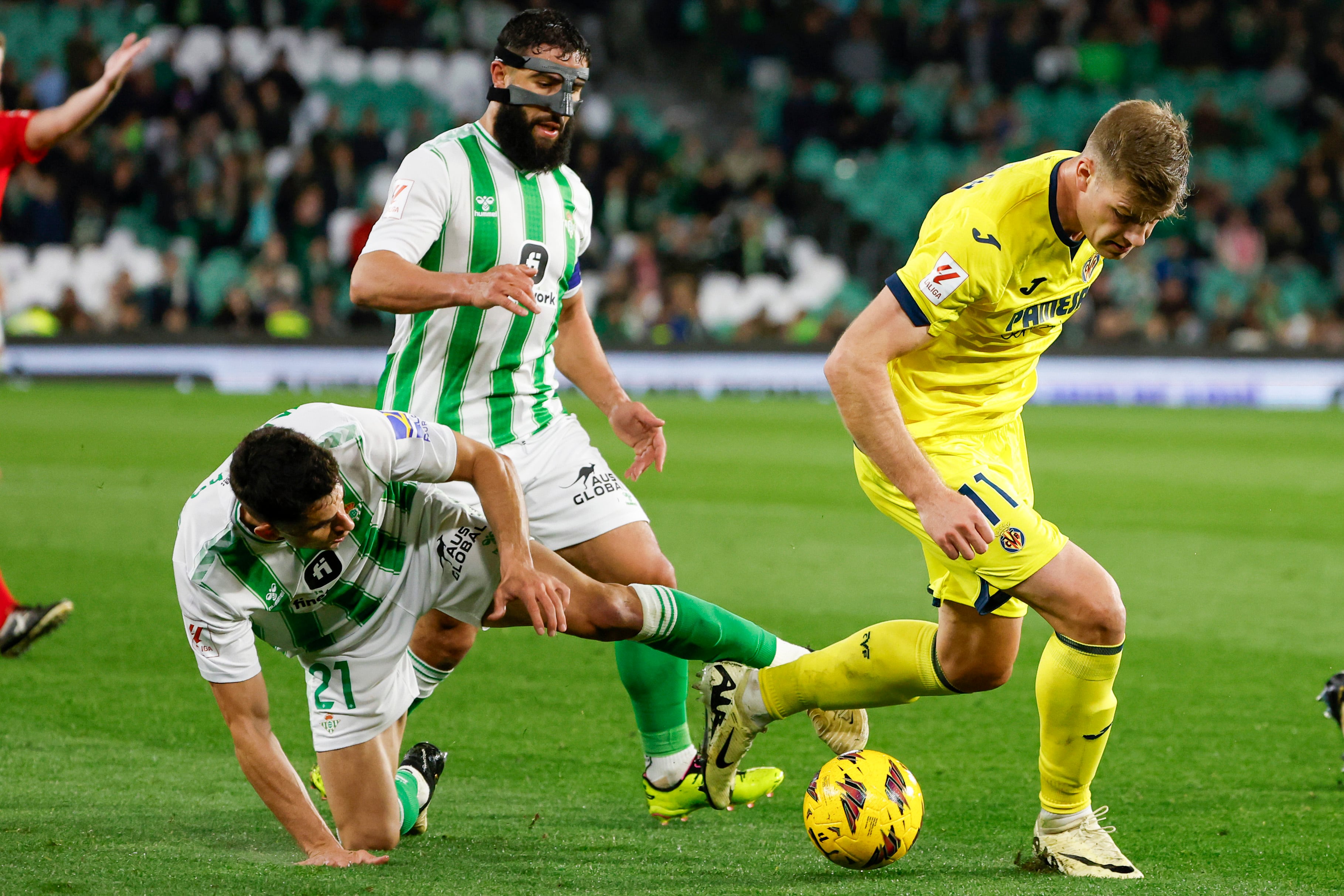 Los jugadores del Real Betis Marc Roca (i) y Nabil Fekir (c) persiguen al noruego Alexander Sorloth, del Villarreal, durante el partido de la Jornada 28 de LaLiga EA Sports que Real Betis y Villarreal CF disputan hoy domingo en el estadio Benito Villamarín. EFE/ Julio Muñoz