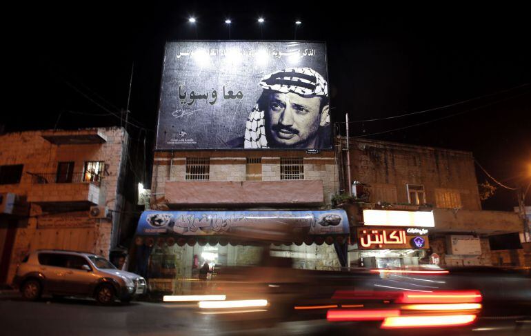 TO GO WITH ARAFAT 10 YEARS PACKAGE  A picture taken on November 3, 2014, shows a giant portrait of late Palestinian leader Yasser Arafat displayed on a street in the Arab east Jerusalem neighbourhood of Beit Hanina. Arafat&#039;s death on November 11, 2004 st