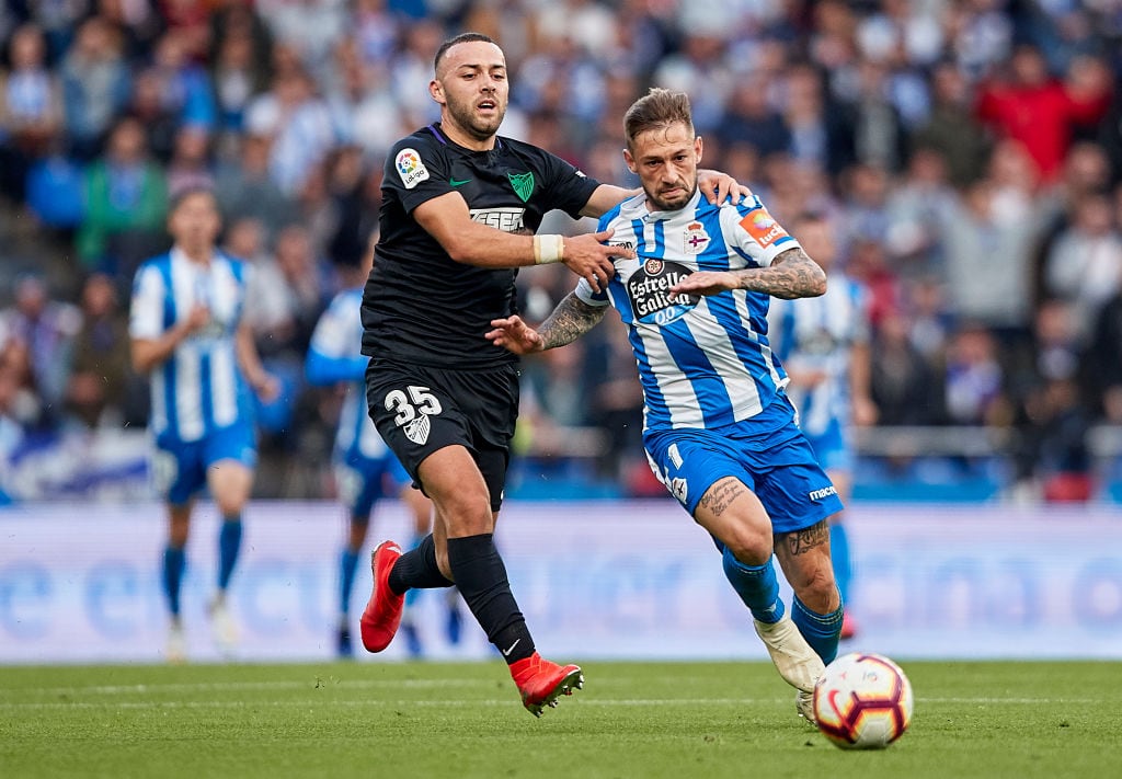 LA CORUNA, SPAIN - JUNE 12: Keidi Bare of Malaga CF competes for the ball with Fede Cartabia of Deportivo de La Coruna during the La Liga 123 play off match between Deportivo De La Coruna and Malaga CF at Estadio Abanca-Riazor on June 12, 2019 in La Coruna, Spain. (Photo by Quality Sport Images/Getty Images)