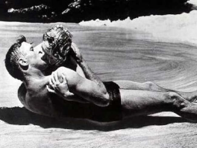 Una idílica playa desierta y el sonido de las olas del mar como único sonido de fondo forman el marco de este beso antológico entre Burt Lancaster y Deborah Kerr.