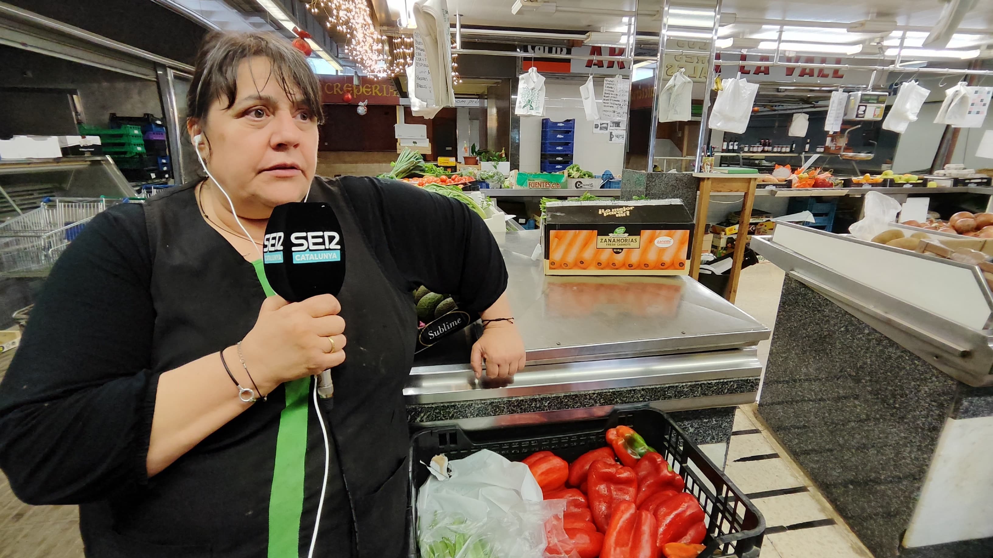 Àgueda Llobera davant de la seva parada de fruita i verdura del mercat de Balàfia mentre era entrevistada per Ràdio Lleida-SER Catalunya.