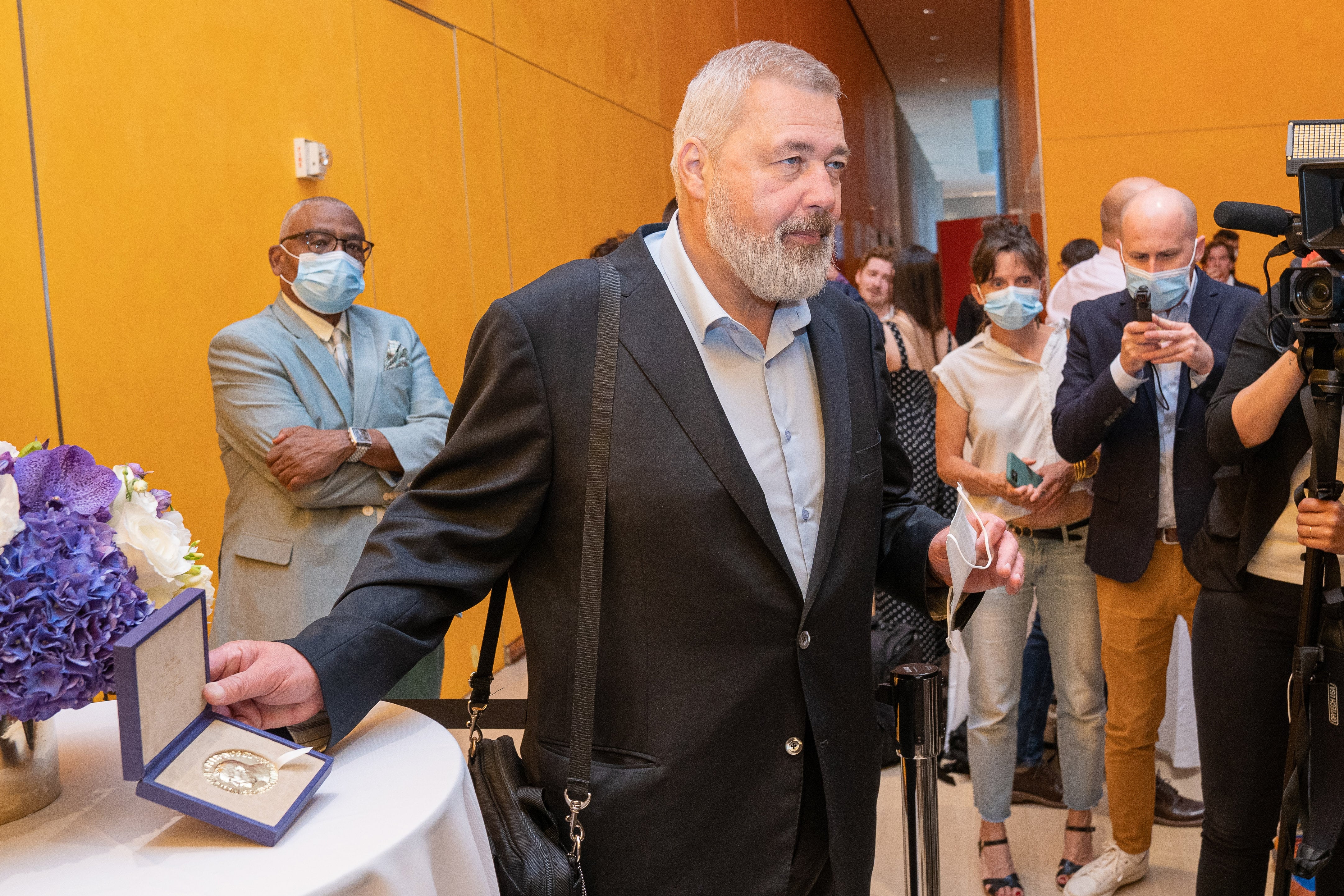 El periodista ruso Dmitry Muratov, posa para los periodistas junto a su Premio Nobel de la Paz, durante el encuentro en Nueva York