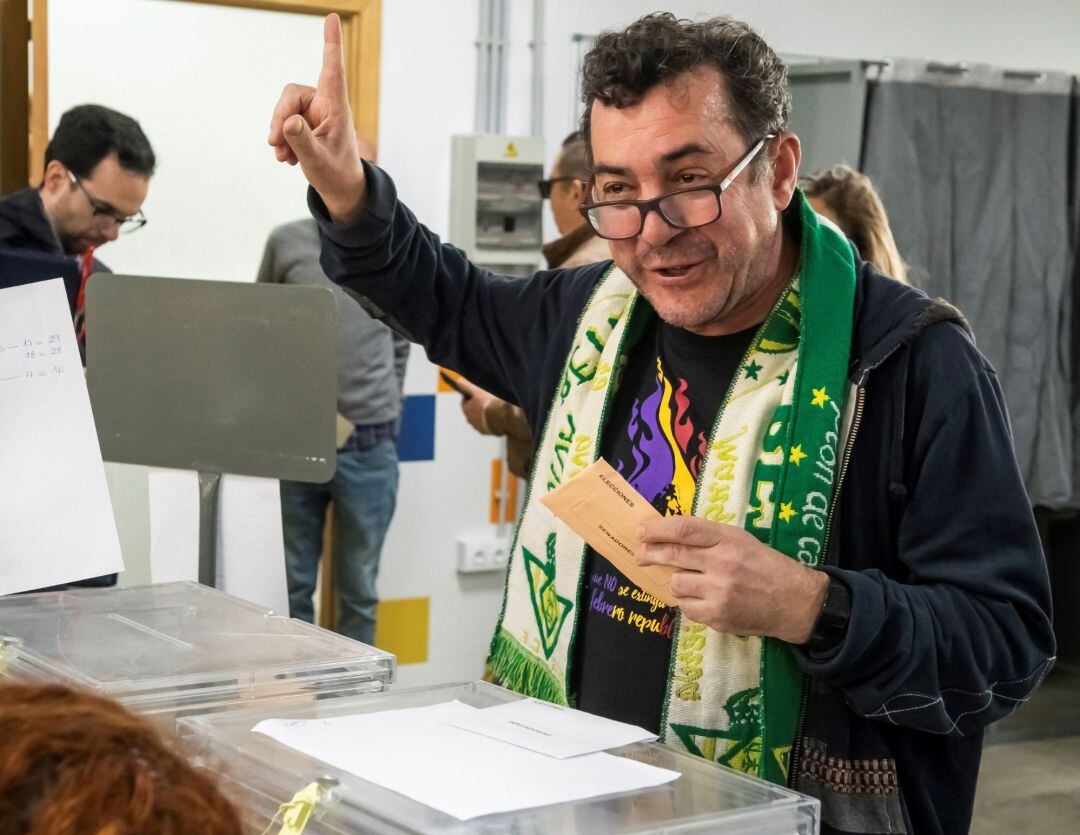 Un ciudadano con camiseta republicana y bufanda del Real Betis, vota durante la jornada electoral de hoy