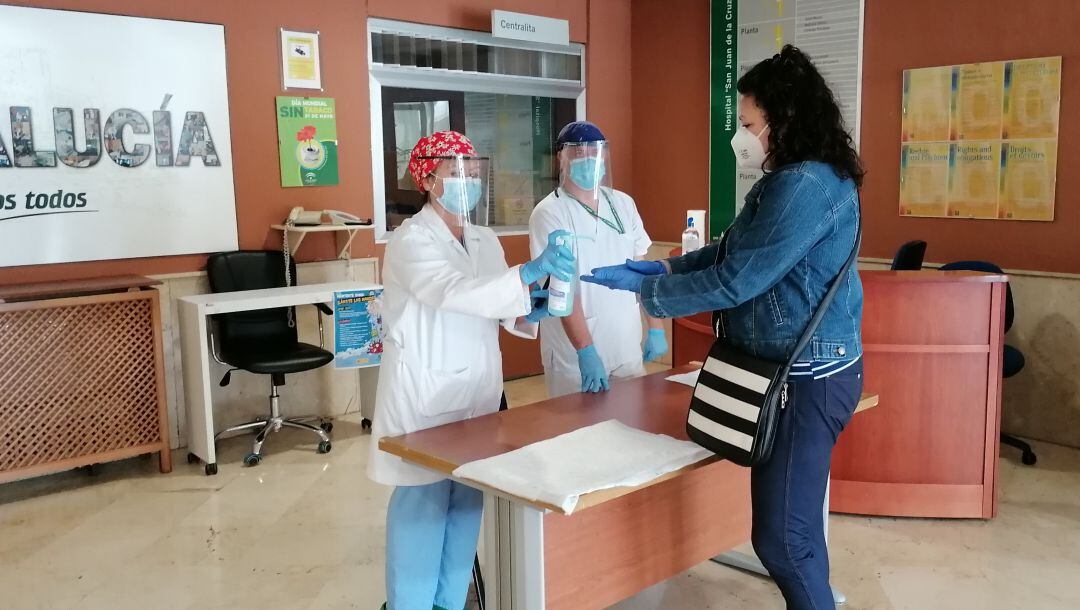 Auxiliares de enfermería proporcionan gel hidroalcohólico a la entrada del hospital de Úbeda