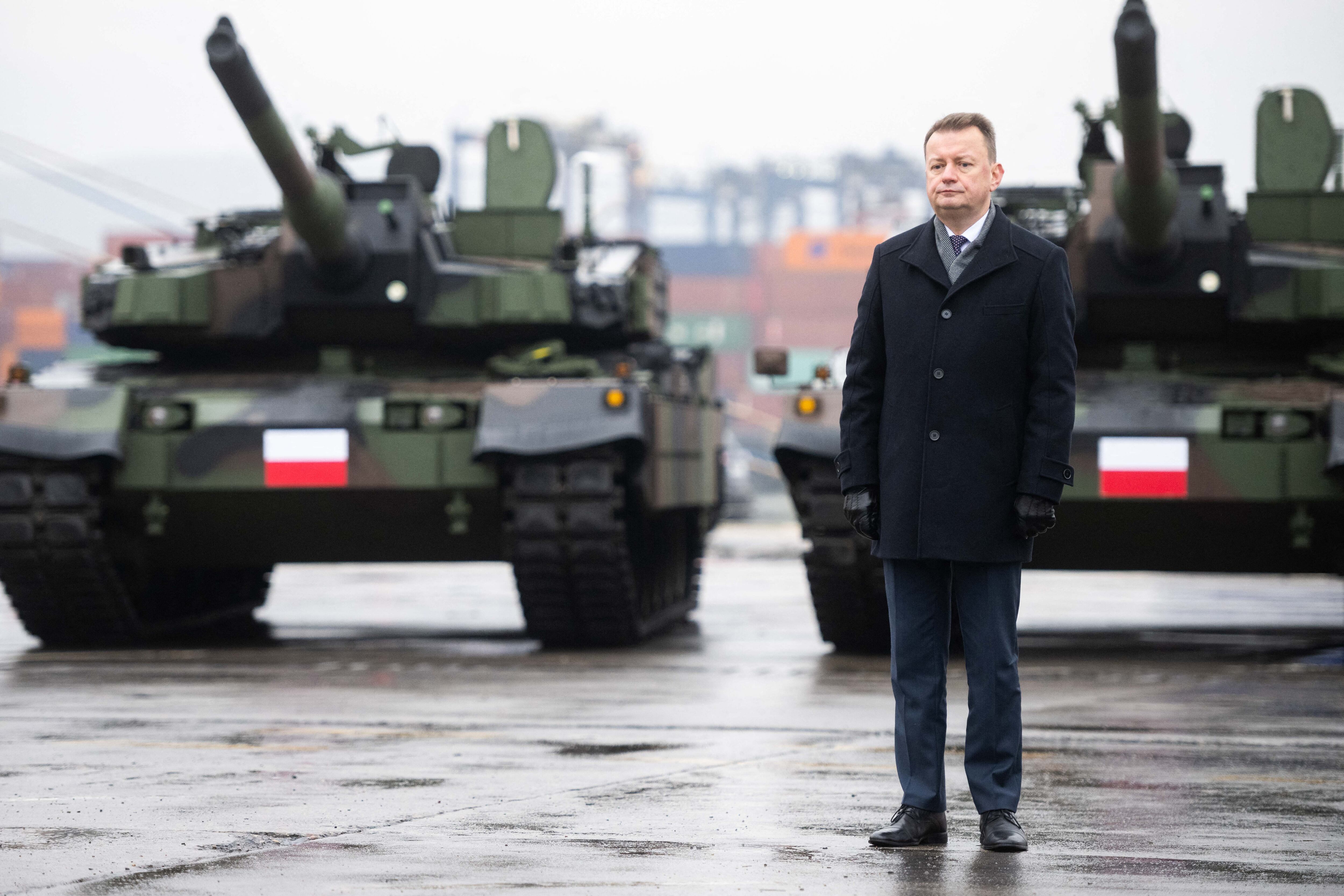 El ministro polaco de Defensa, Mariusz Blaszczak, ante dos tanques de fabricación surcoreana.