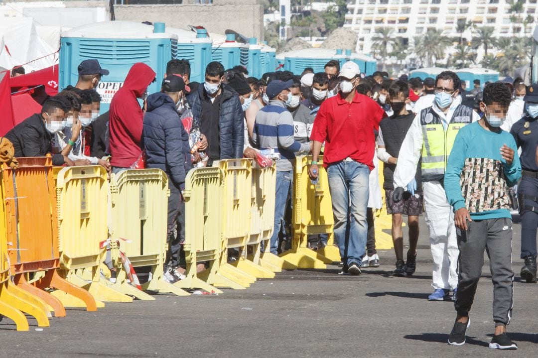 Varios inmigrantes hacen cola en el Muelle de Arguineguín, en Gran Canaria.