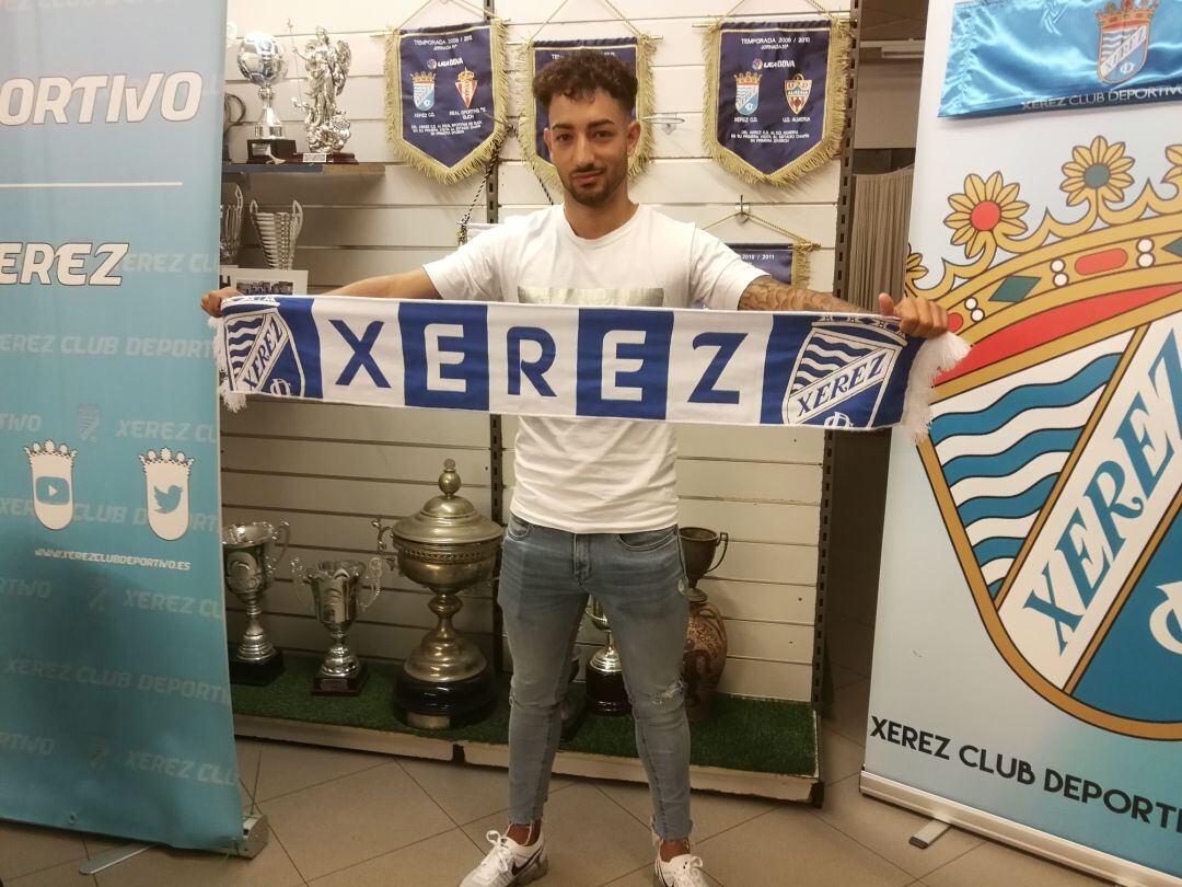 Ángel Jiménez posa con la bandera de su nuevo club. 