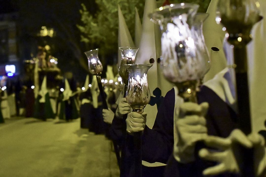 Nazarenos con velas encendidas en sus tulipas 