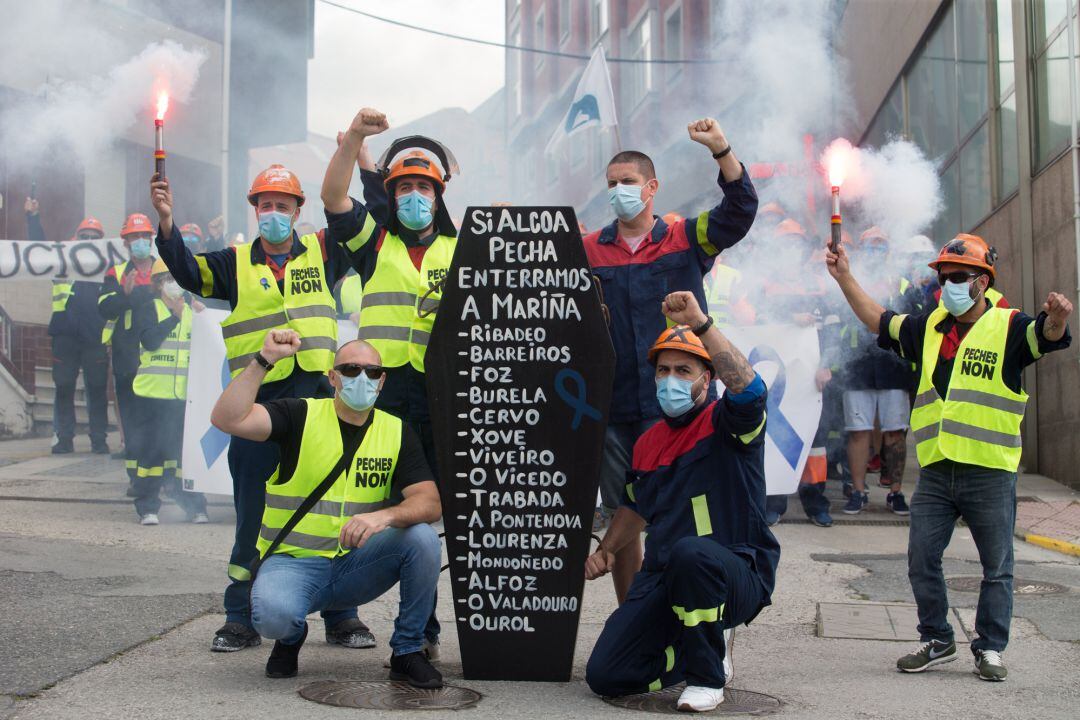 Trabajadores de Alcoa posan junto a un féretro de cartón durante una nueva manifestación tras el anuncio realizado por la empresa hace más de 15 días del despido colectivo de hasta 534 trabajadores de los 610 de sus dos factorías en San Cibrao, concretamente en la planta que fabrica aluminio, en Foz, Lugo, Galicia (España) a 14 de junio de 2020.