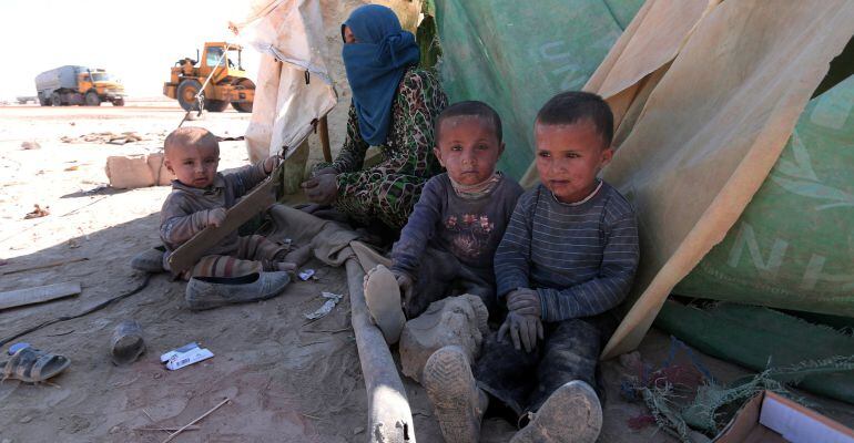 Iraqi refugees rest near a tent in al-Howl refugee camp, south of Hasaka city, Syria October 20, 2016