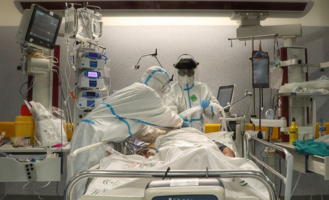 Facultativos atienden a un paciente con COVID-19 en la UCI.
