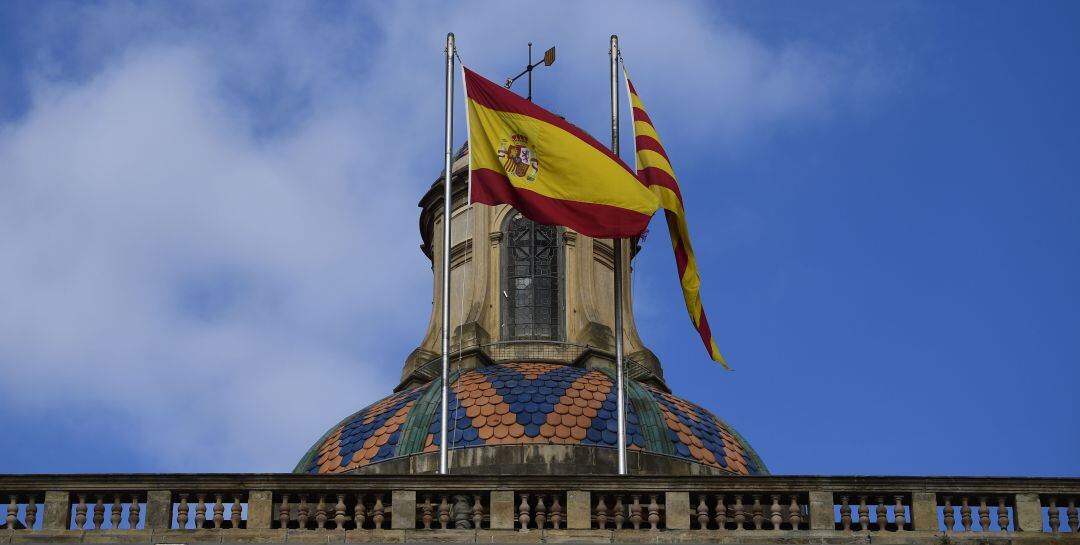 Imagen de archivo de las banderas española y catalana en el tejado del palacio de la Generalitat de Catalunya