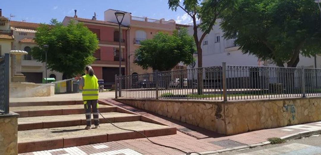 Una mujer limpia y desinfecta un parque en Torreperogil.