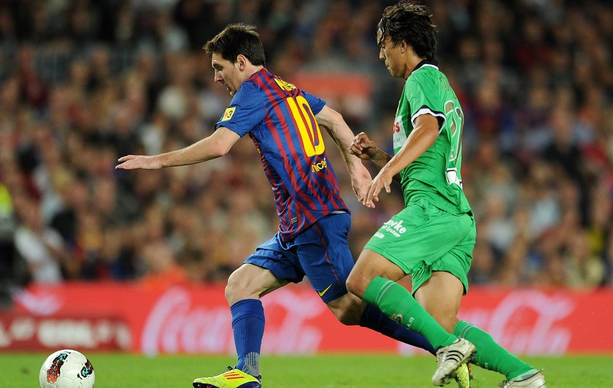 BARCELONA, SPAIN - OCTOBER 15:  Lionel Messi of FC Barcelona duels for the ball with Edu Bedia of Racing Santander during the la Liga match between FC Barcelona and Real Racing Club at the Camp Nou stadium on October 15, 2011 in Barcelona, Spain.  (Photo by Jasper Juinen/Getty Images)