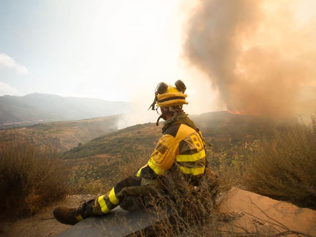 Un bombero observa el incendio forestal, a 24 de agosto de 2025, en La Baña, Encinedo, La Cabrera, León, Castilla y León
