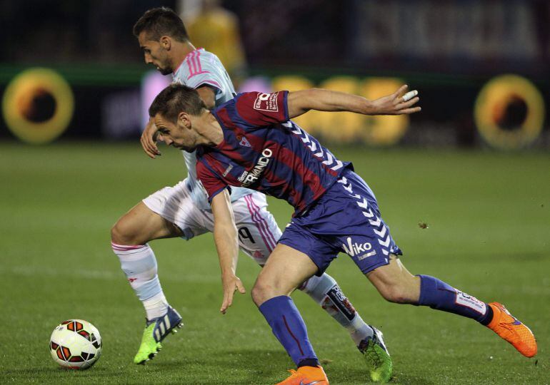 GRA346. EIBAR (GIPUZKOA), 19/04/2015.- El lateral del Celta Jonny (i) trta de escapar de Borja, del Eibar, durante el partido de Liga en Primera División que se disputa esta noche en el estadio de Ipurua, en Eibar. EFE/Juan Herrero