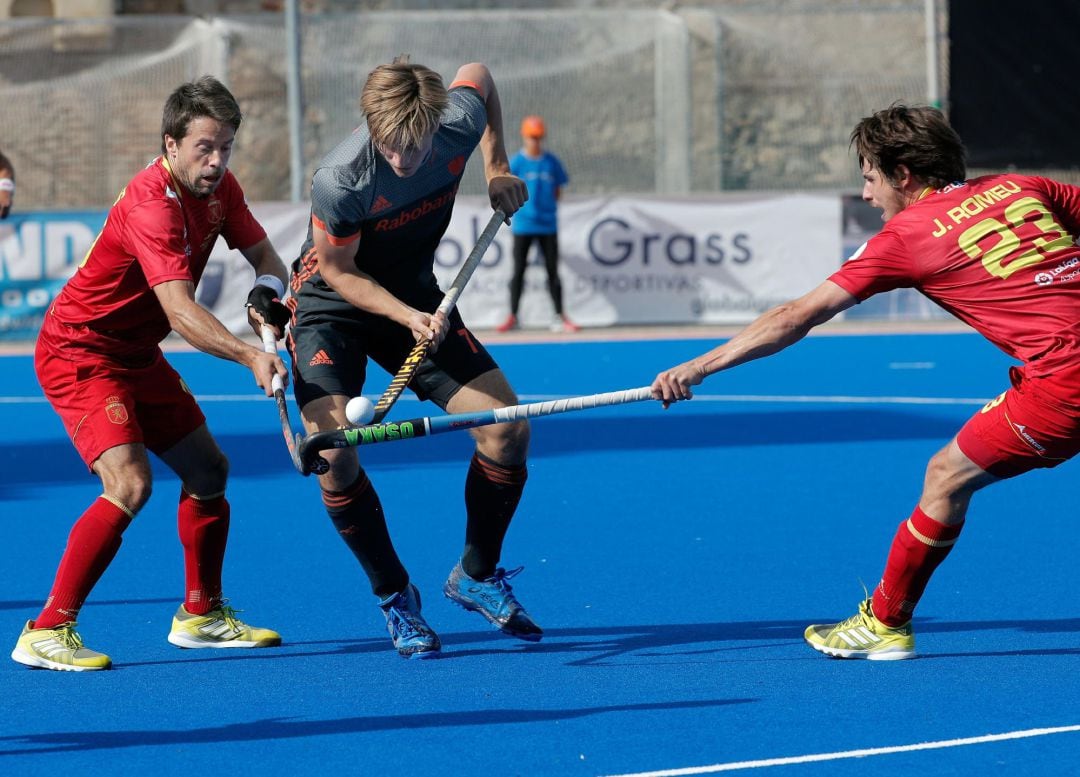 Los jugadores españoles Josep Romeu (i) y Marc Salles (d) pelean una bola con el holandés Jorrit Croon