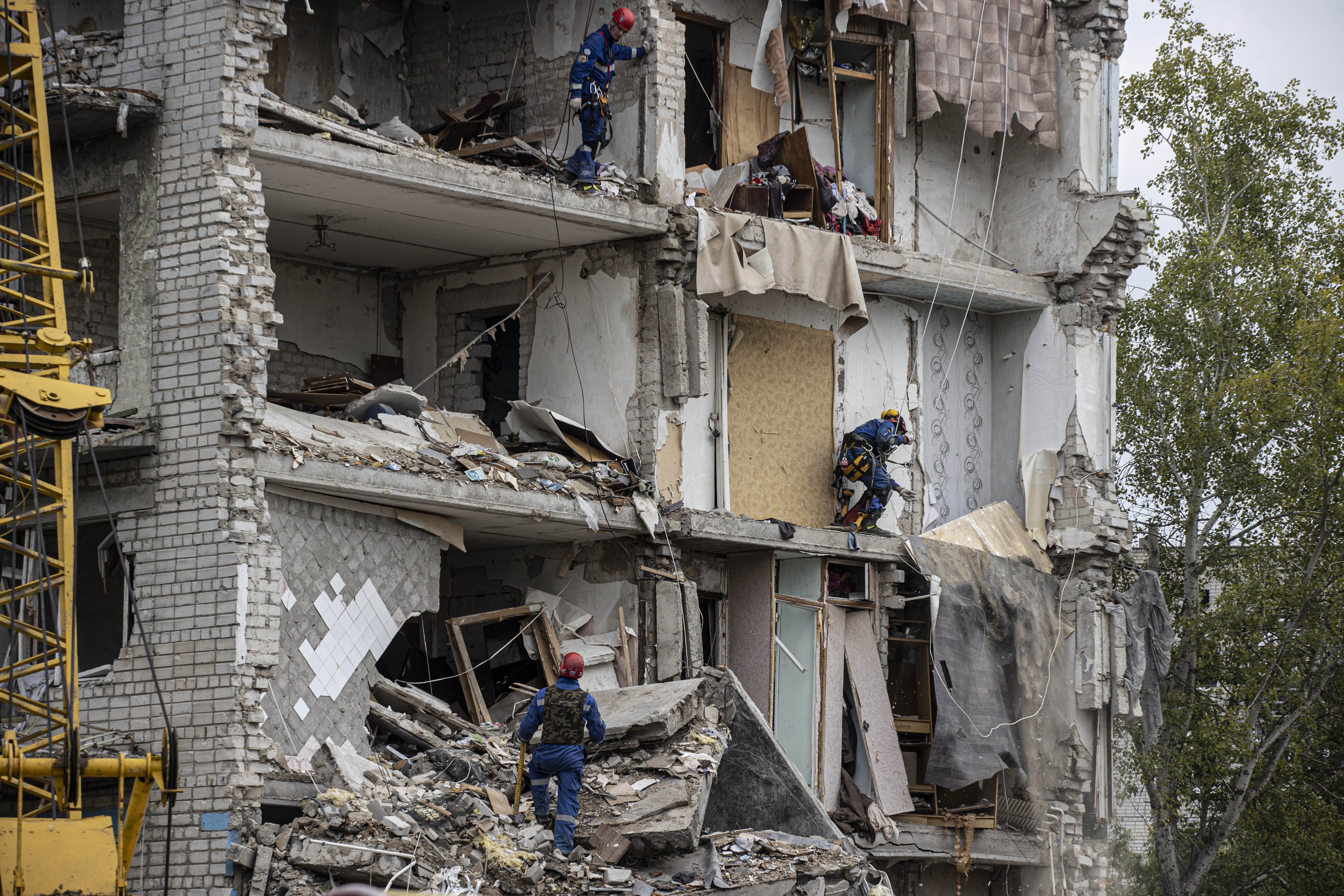 Los bomberos trabajan en un edificio destruido en Izium