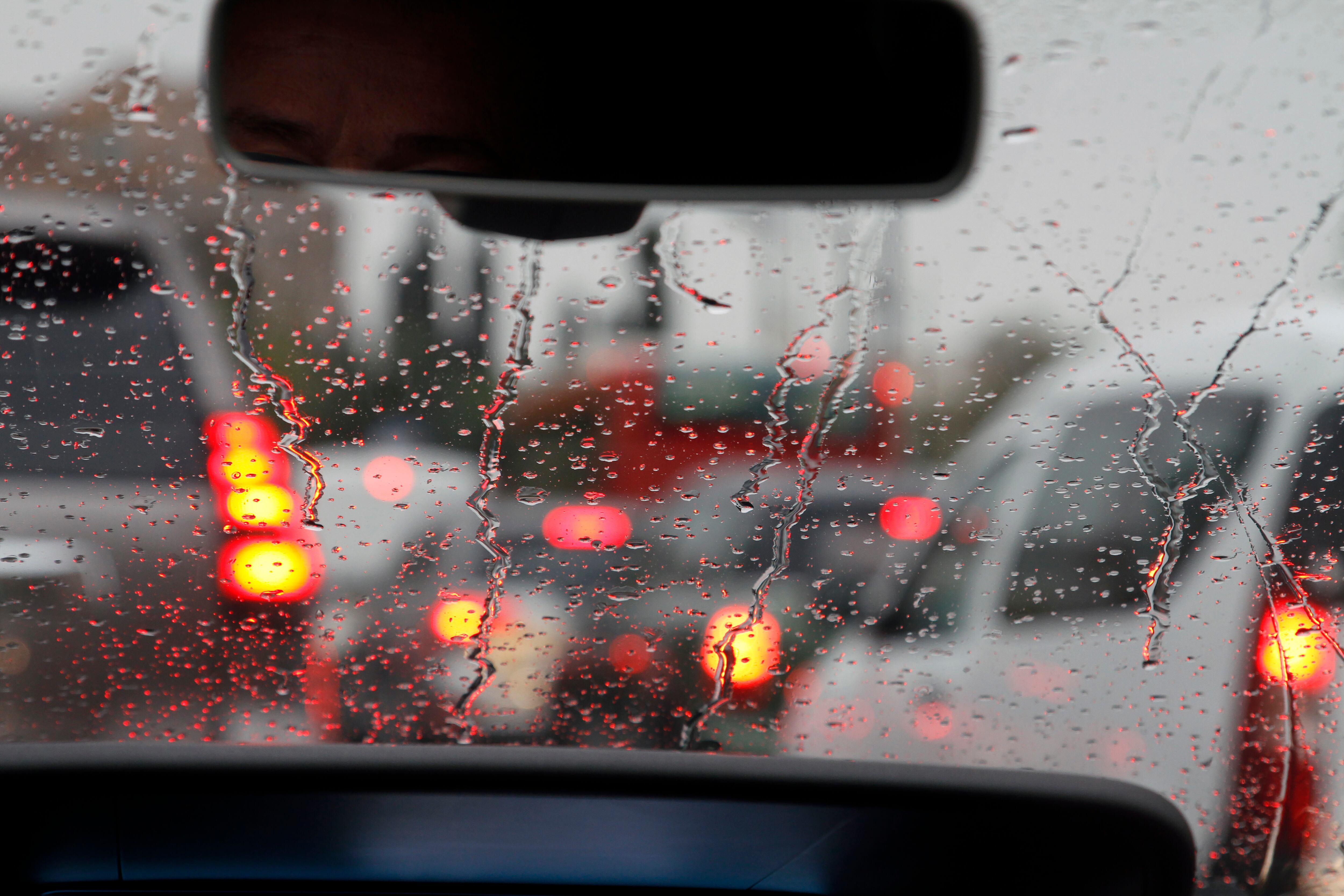 View from car with rain drops of traffic jam in the street