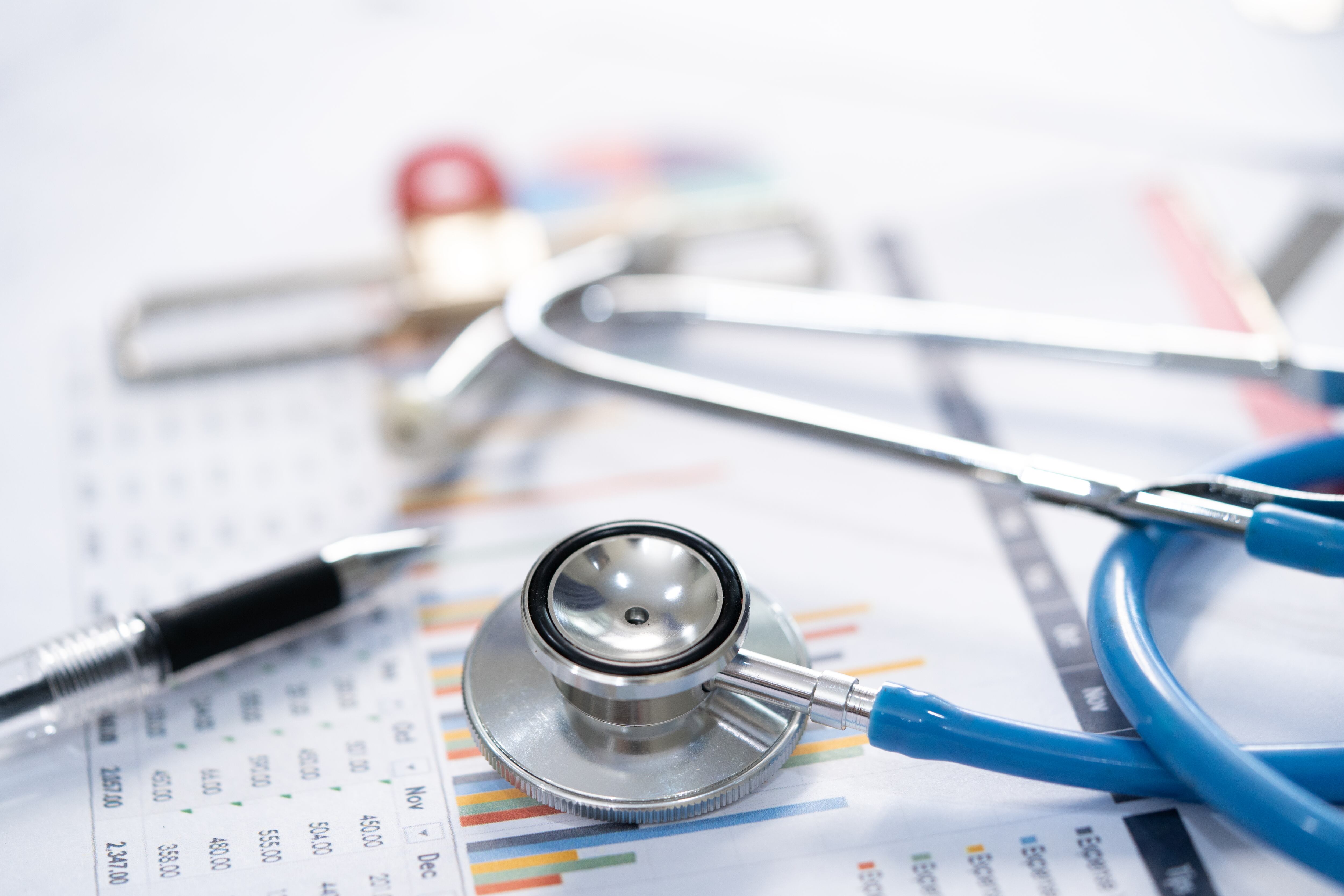 Stethoscope and Charts , Saving stack coins money, globe and credit card. Finance, Account, Statistics, Investment, Analytic research data economy and Business company meeting concept.