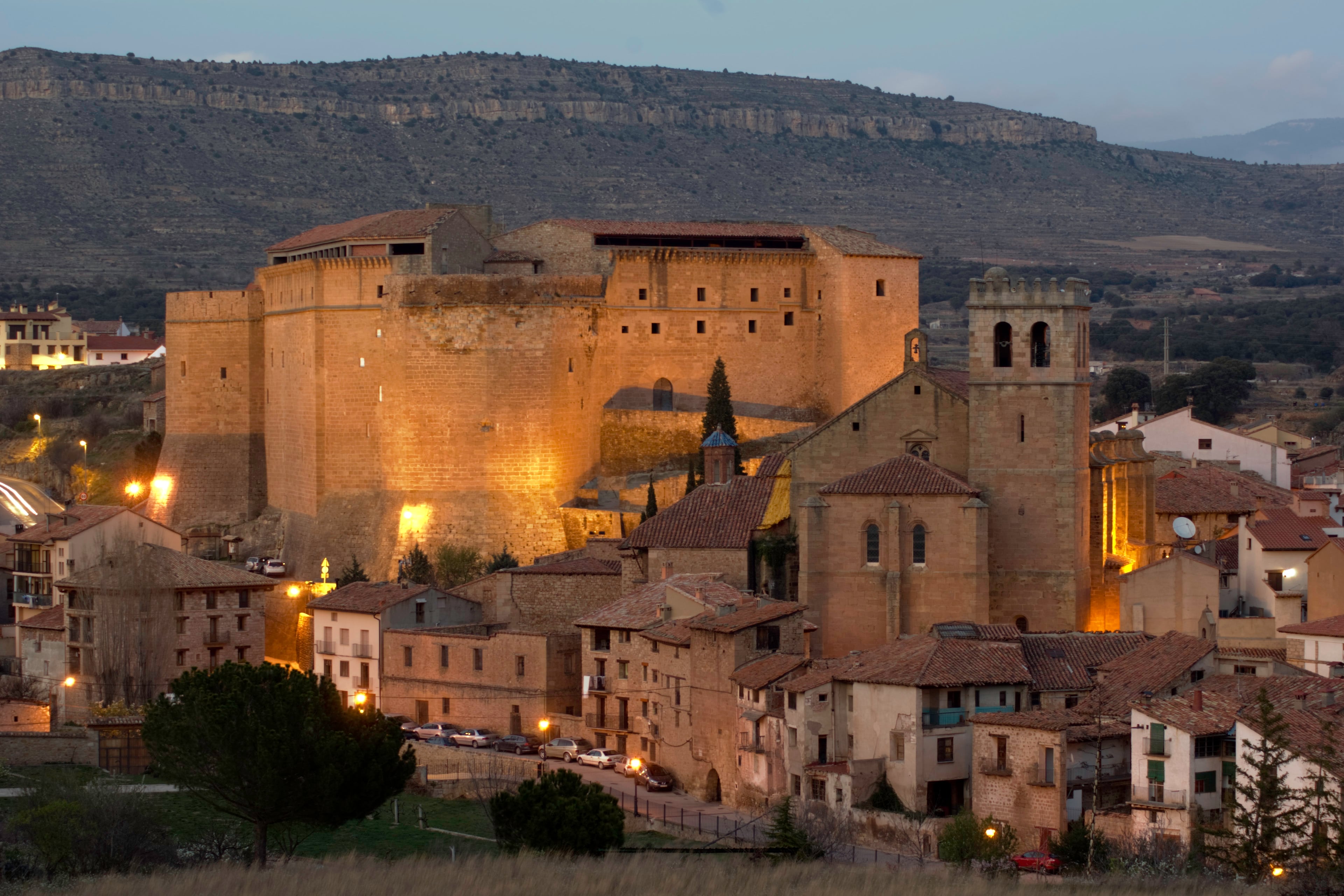 View of the spanish medieval castle and church of Mora de Rubielos (Teruel, Aragon, Spain) at sunset.