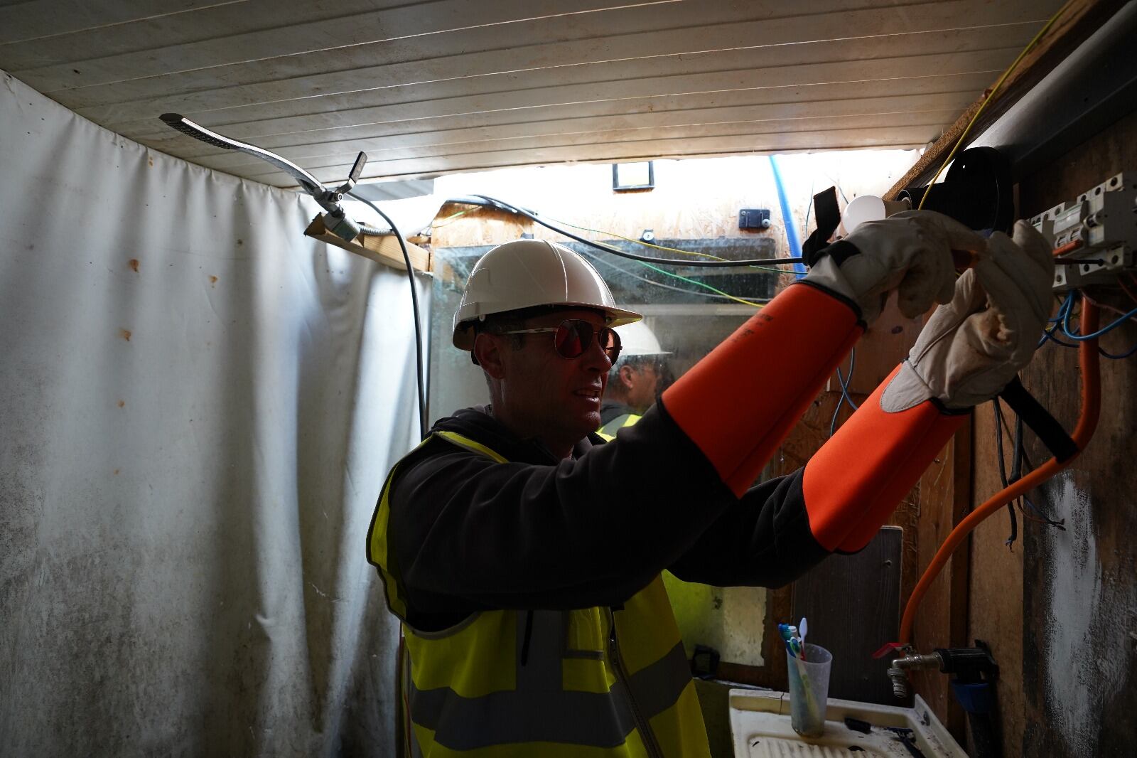 Técnicos del Ayuntamiento cortando el suministro eléctrico en el contador que se había montado en el asentamiento