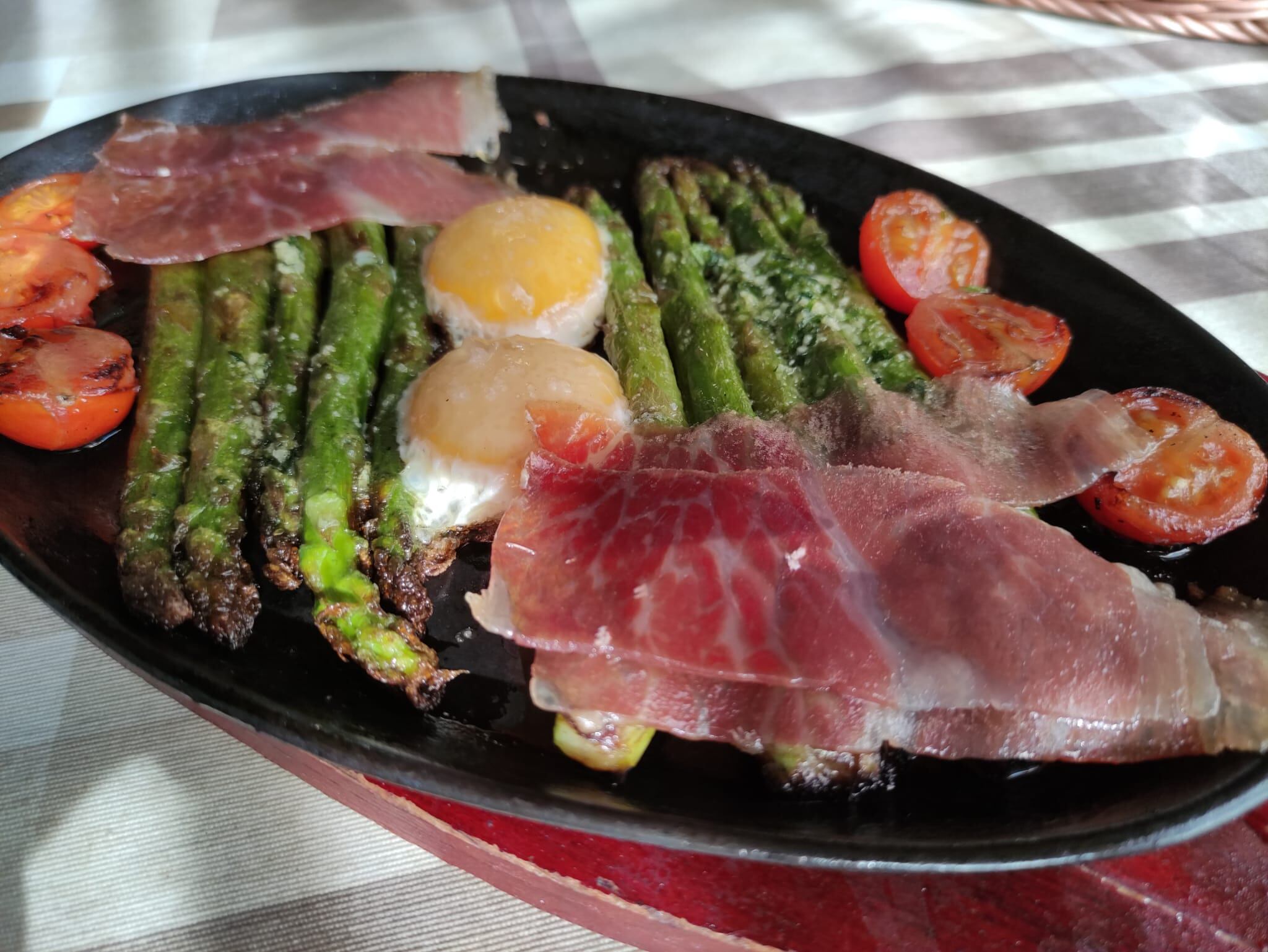 Huevos de campo con espárragos verdes, tomatitos cherry y jamón ibérico