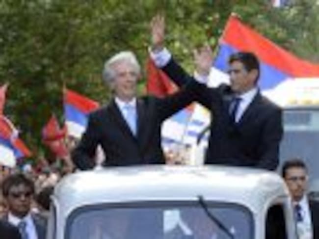 The new Uruguayan President Tabare Vazquez (L) and his Vice President Raul Sendic wave at the crowd gathering along his way from the Legislative Palace to Independence Square in Montevideo on March 1, 2015. Cancer doctor Tabare Vazquez was sworn in as Uru