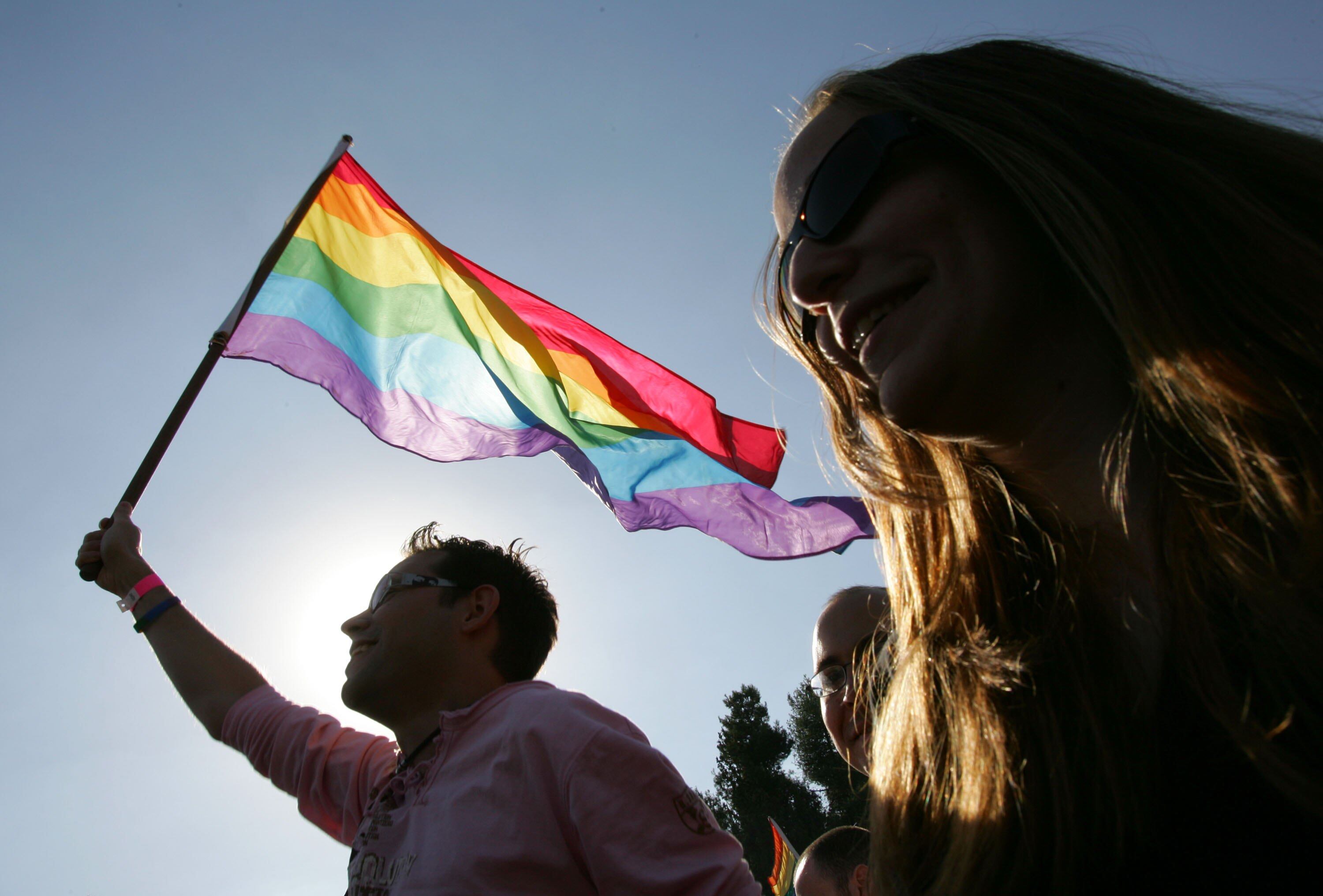 JERUSALEM, ISRAEL - NOVEMBER 10:  An Israeli homosexual dances with a rainbow flag at a Gay Pride rally November 10, 2006 in Jerusalem. About 2,000 alternative lifestyle Israelis were in attendance after ultra-Orthodox Jewish leaders compromised on the rally following a week of violent protests with the police over the planned Gay Pride parade through the streets of Jerusalem.  (Photo by David Silverman/Getty Images)