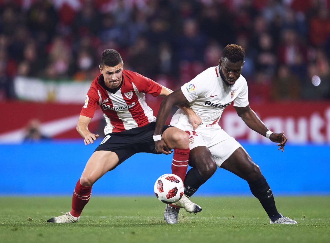 Joris Gnagnon of Sevilla FC competes for the ball with Gorka Guruzeta of Athletic Club during the Copa del Rey Round of 16 second leg match between Sevilla FC and Athletic Club Bilbao at Estadio Ramon Sanchez Pizjuan