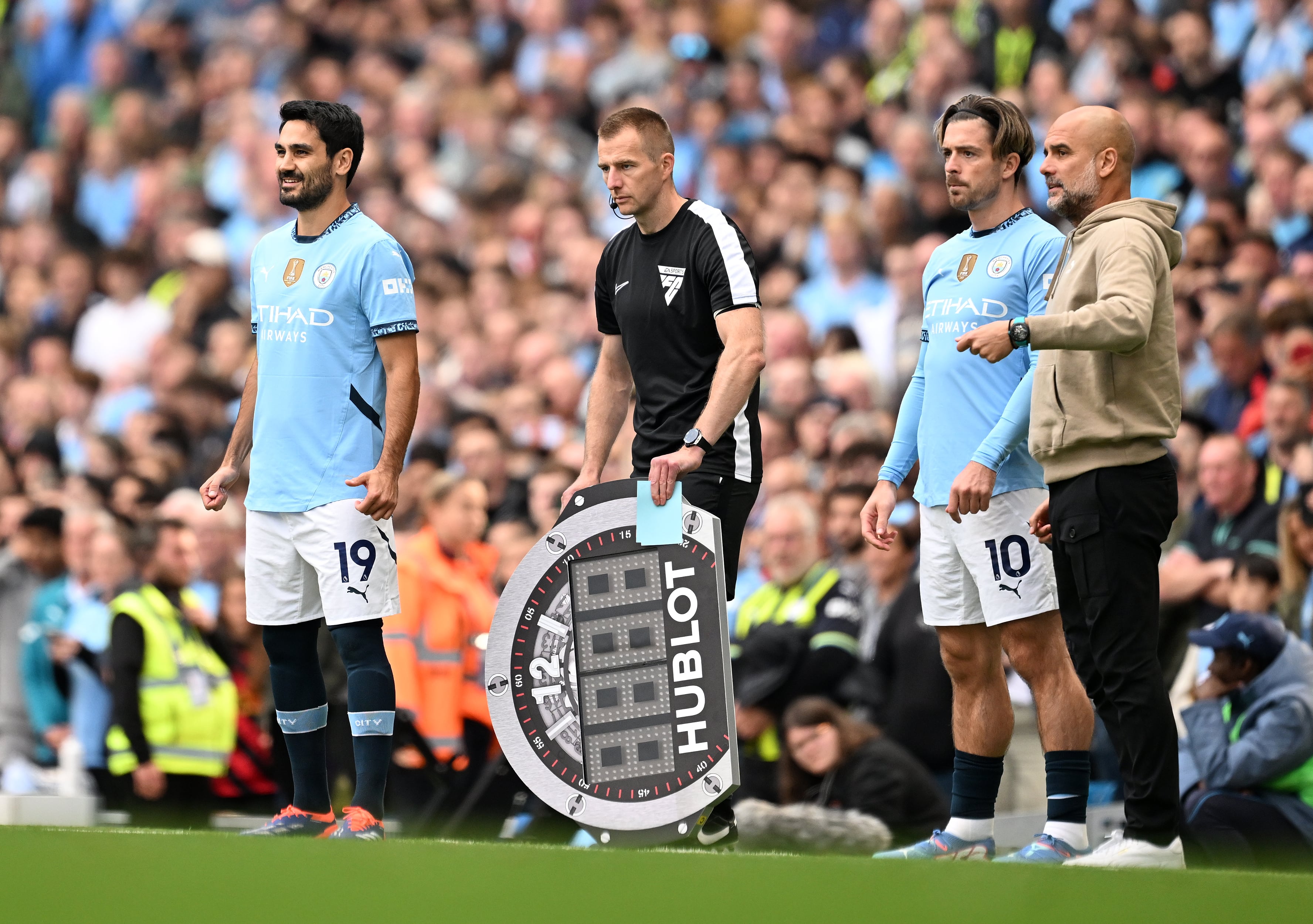 Gundogan esperando el cambio junto a Jack Grealish