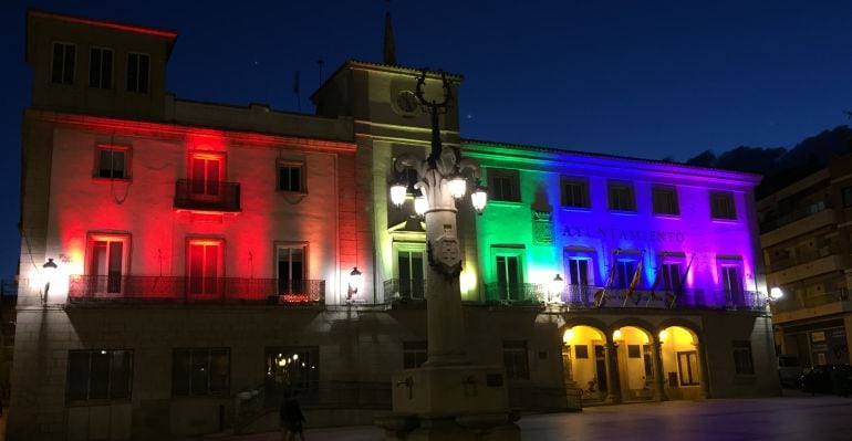 Fachada de consistorio de Colmenar Viejo iluminada con la bandera LGTBI