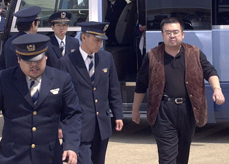 A man (R) believed to be North Korean heir-apparent Kim Jong Nam, is escorted by police as he boards a plane upon his deportation from Japan at Tokyo&#039;s Narita international airport in Narita, Japan,