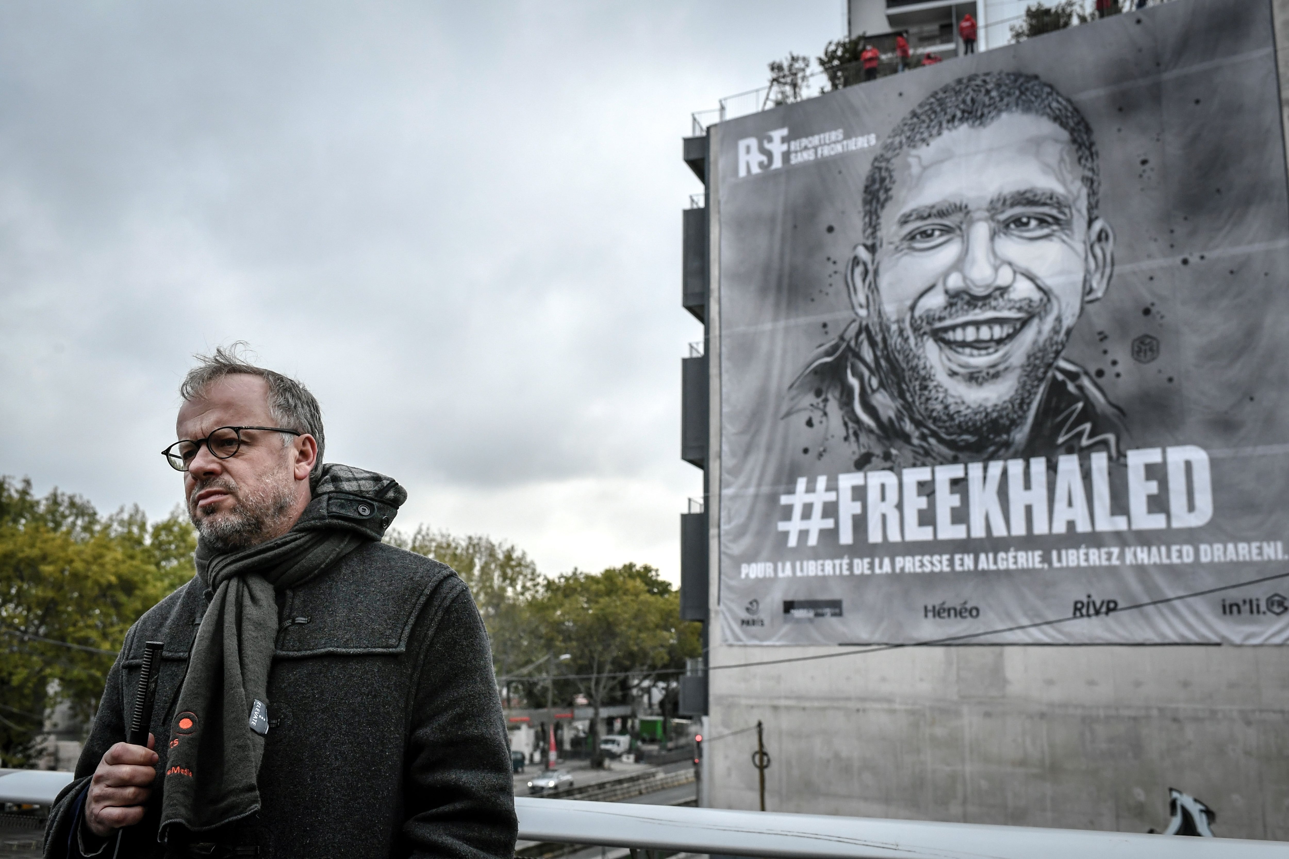 Secretary general of International press freedom watchdog Reporters sans frontieres (RSF- Reporters Without Borders) Christophe Deloire delivers a speech during the installation of a tarp depecting jailed Algerian journalist Khaled Drareni by French street-artist C215 on October 15, 2020 in Paris. - Drareni, 40, was sentenced to two years in jail for his coverage of the mass protest movement that toppled Algeria&#039;s longtime president last year. (Photo by STEPHANE DE SAKUTIN / AFP) / RESTRICTED TO EDITORIAL USE - MANDATORY MENTION OF THE ARTIST UPON PUBLICATION - TO ILLUSTRATE THE EVENT AS SPECIFIED IN THE CAPTION (Photo by STEPHANE DE SAKUTIN/AFP via Getty Images)