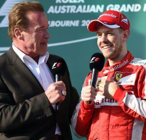 Hollywood actor Arnold Schwarzenegger (L) interviews Ferrari&#039;s German driver Sebastian Vettel (R) after the Formula One Australian Grand Prix in Melbourne on March 15, 2015. AFP PHOTO / William WEST --IMAGE RESTRICTED TO EDITORIAL USE - STRICTLY NO COMMER