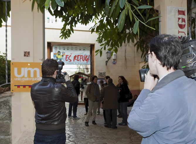 Un reportero de televisión graba la entrada a la sede de la formación política Unión Mallorquina de Palma, que está siendo registrada por encargo de los fiscales anticorrupción