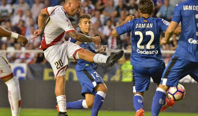 El jugador del &#039;Rayo&#039; Patrick Ebert (20) dispara a puerta con la oposición de los getafenses Portillo (12), Damián (22) y Van den Bergh (3)