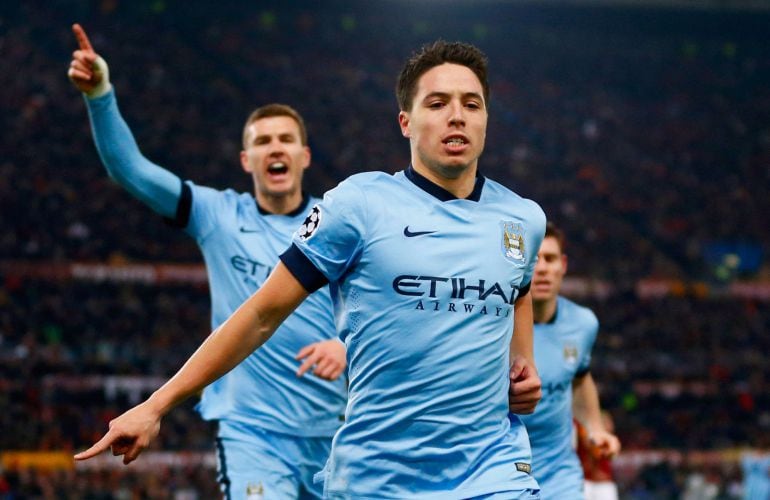 ROME, ITALY - DECEMBER 10:  Samir Nasri of Manchester City (front) celebrates with Edin Dzeko (L) as he scores their first goal during the UEFA Champions League Group E match between AS Roma and Manchester City FC at Stadio Olimpico on December 10, 2014 i