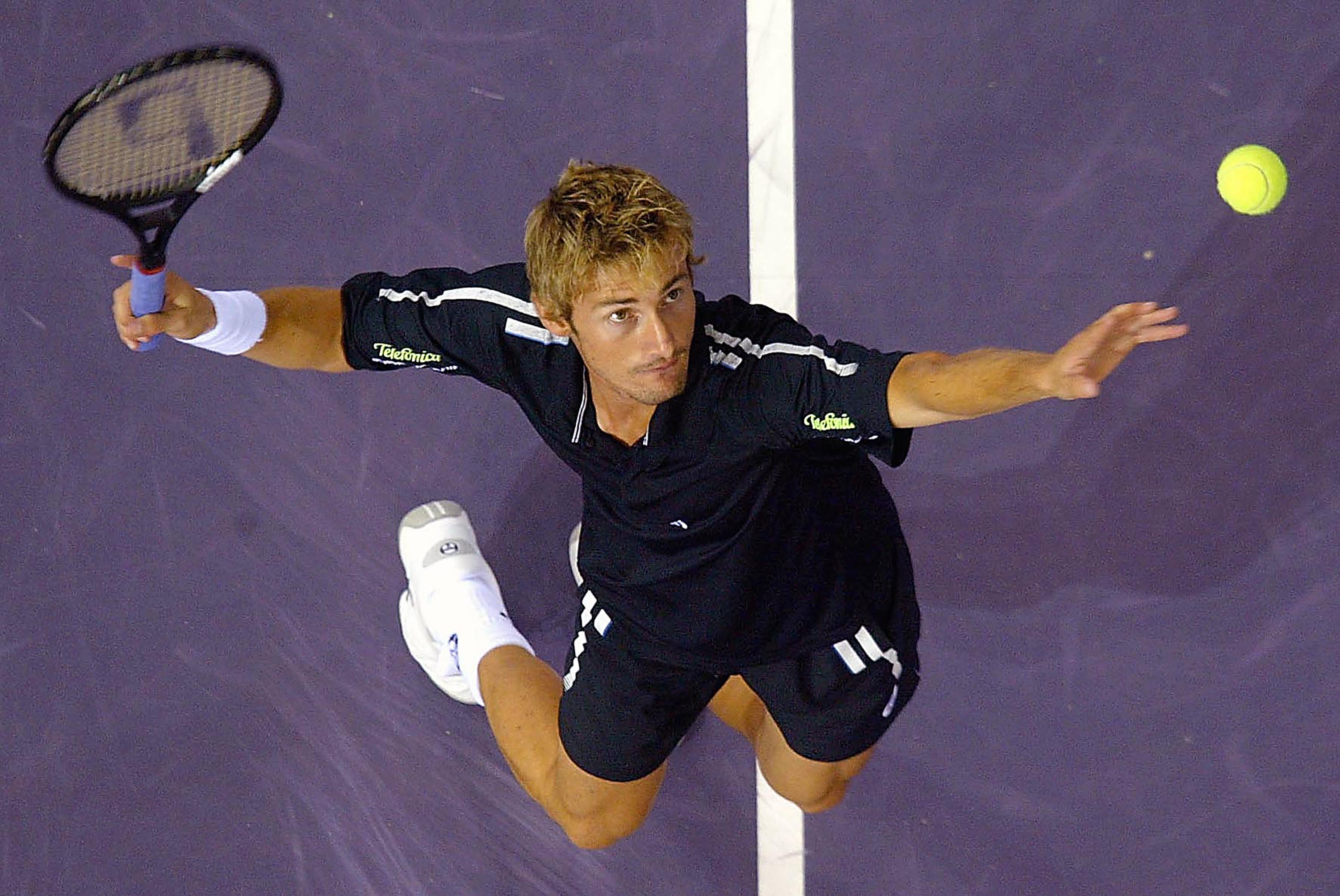 MADRID, SPAIN - OCTOBER 17:  Juan Carlos Ferrero of Spain serves to his quarter-final opponent Paradorn Srichapan of Thailand at the ATP Madrid Masters at the Nuevo Rockodromo on October17, 2003 in Madrid. (Angel Perez/POOL/Getty Images)