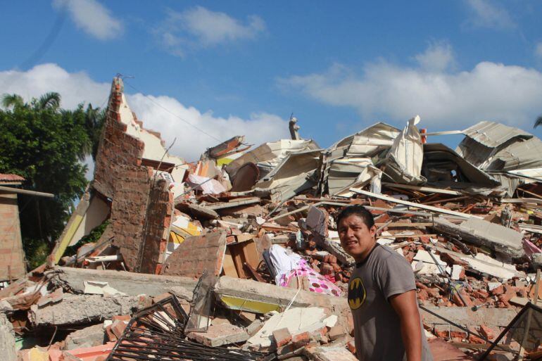 Un hombre camina junto a un hotel desplomado tras el fuerte seismo en la zona hotelera de Tarqui en Manta (Ecuador) 