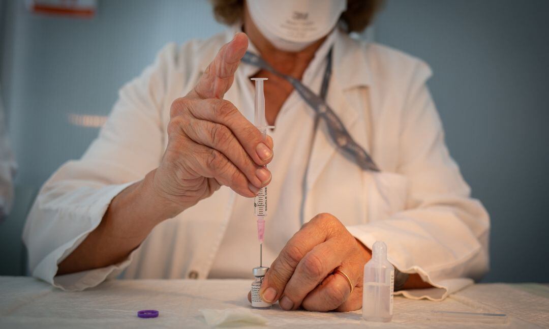 Una enfermera prepara la vacuna Pfizer-BioNtech contra el COVID-19 antes de administrársela a un profesional sanitario en el Hospital de la Santa Creu i Sant Pau de Barcelona, Catalunya (España), a 14 de enero de 2021.