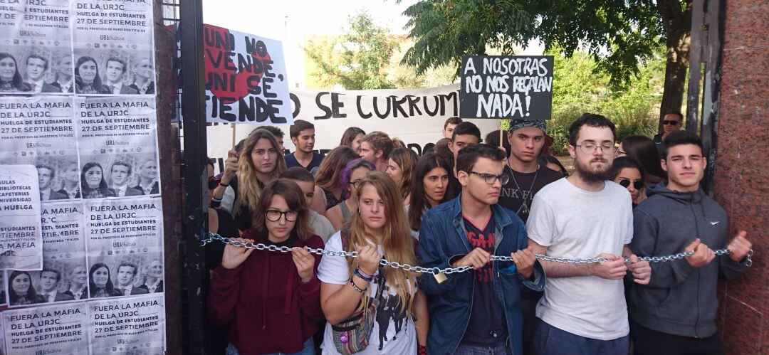 Varios estudiantes en uno de los accesos al campus