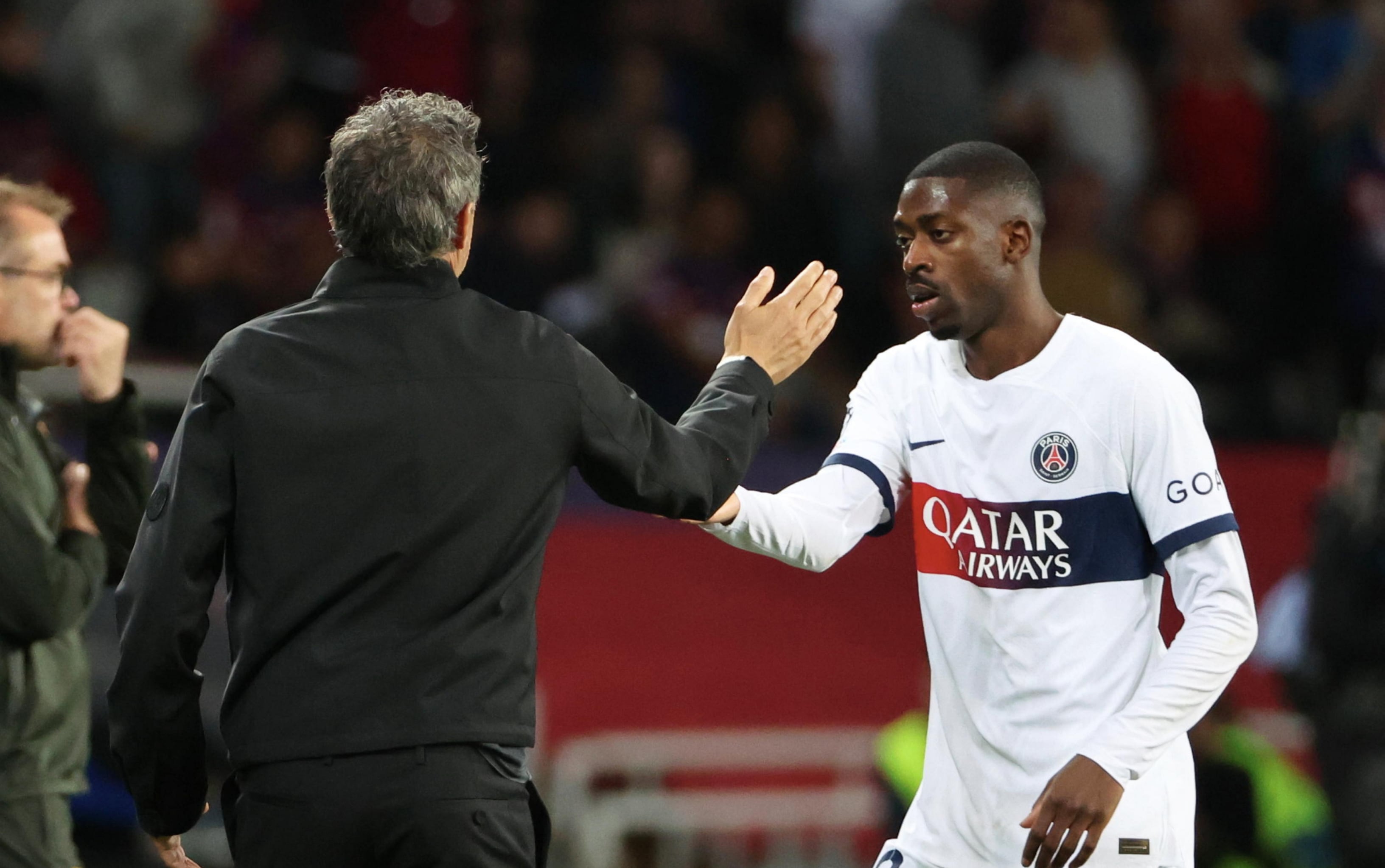 Ousmane Dembélé y Luis Enrique se saludan tras un partido del PSG