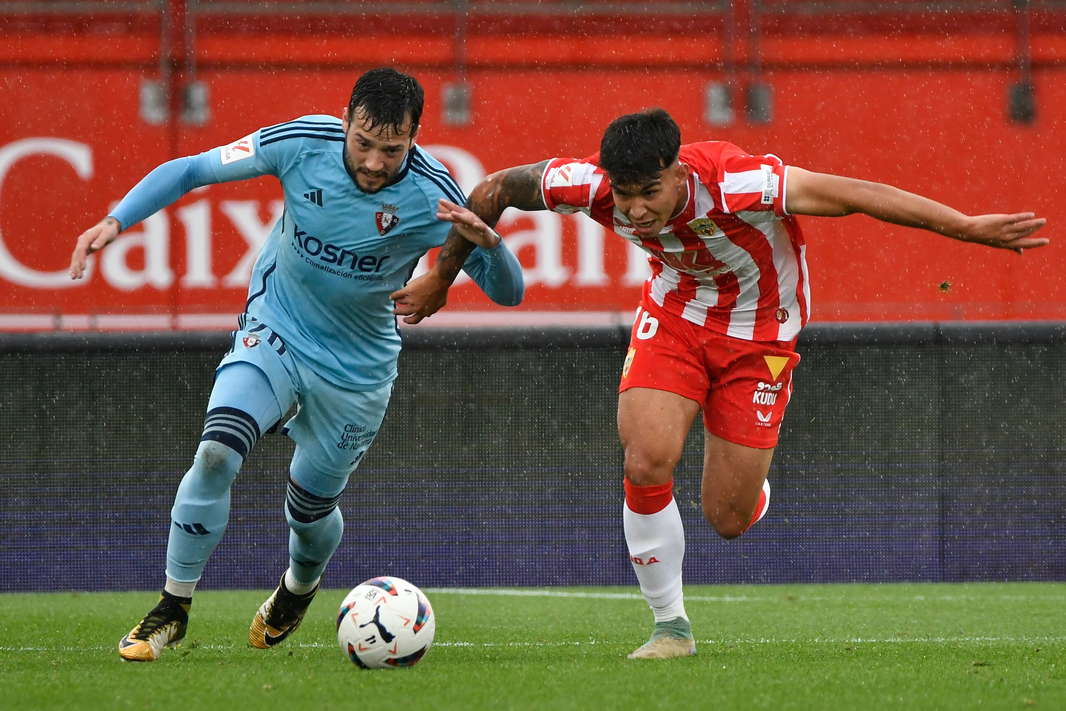 El jugador de la U.D. Almería Peña (d) disputa un balón con el jugador de Osasuna Arnaiz, durante el partido de LaLiga EA Sports de la jornada 30 disputado esta tarde en el Power Horse Stadium de Almería (Andalucía)